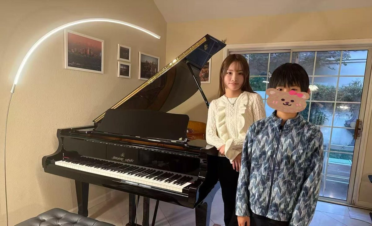 Family with their Shigeru Kawai grand piano at home